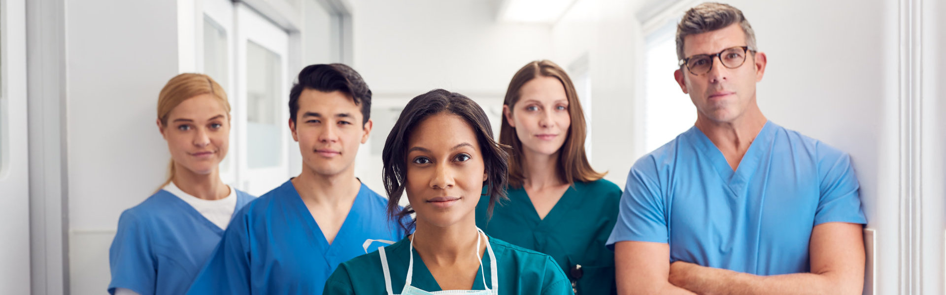 portrait of medical team standing in hospital corridor