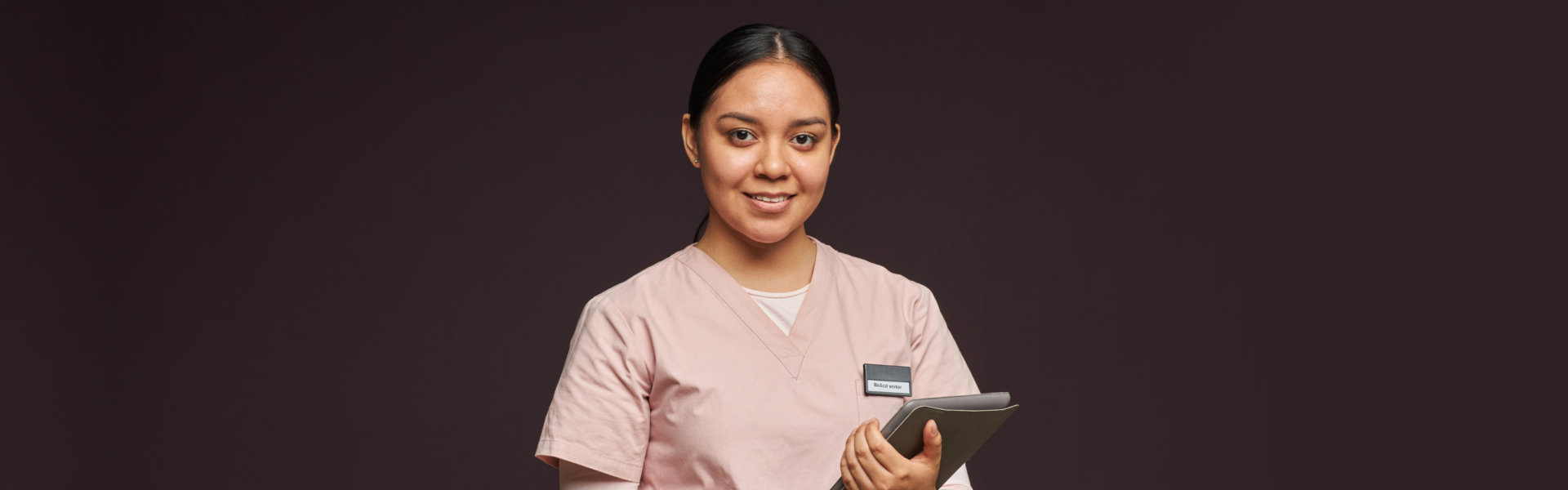 portrait of medical staff smiling holding a book